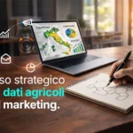 L'uso strategico dei dati agricoli nel marketing. Come usare i dati agricoli per migliorare targeting, DEM e campagne di marketing. Persona in ufficio che guarda il computer, analizza i dati per targeting, campagne e risultati e prende appunti.